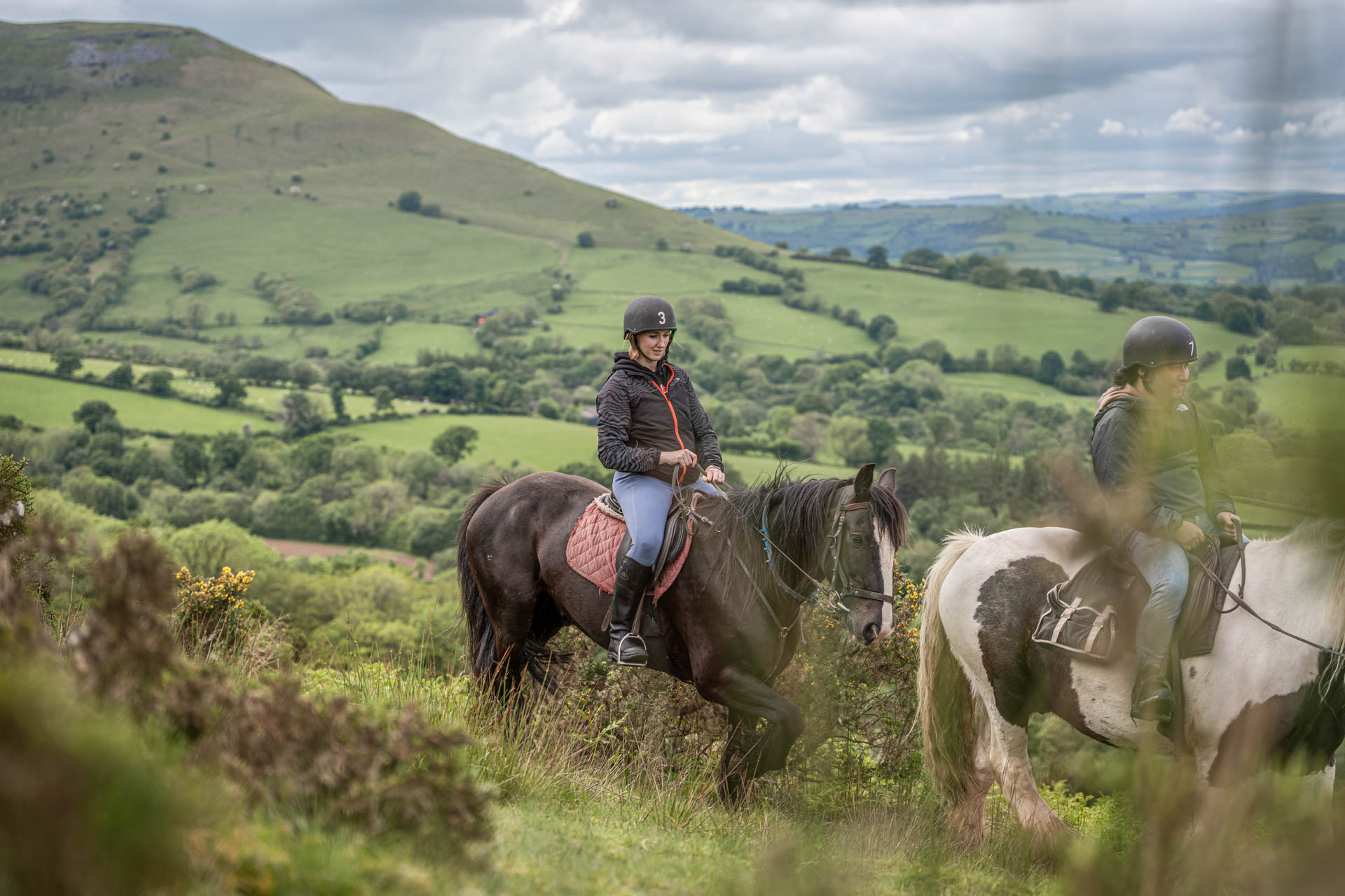 A close up image of a rider on horseback against a backdrop of the stunning Brecon Beacons.