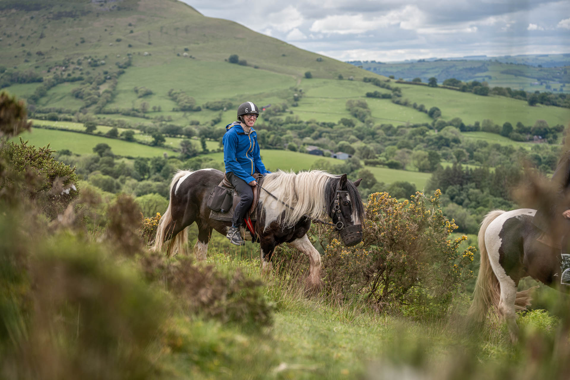 A close up image of a rider on horseback against a backdrop of the stunning Brecon Beacons.